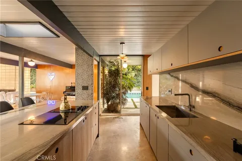a kitchen with stainless steel appliances a sink stove and cabinets