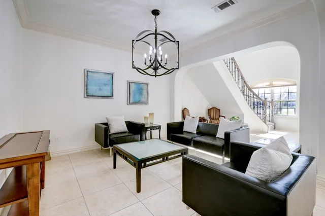 a living room with furniture a rug and white walls
