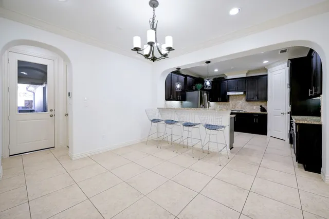 a view of a kitchen with cabinets and stainless steel appliances