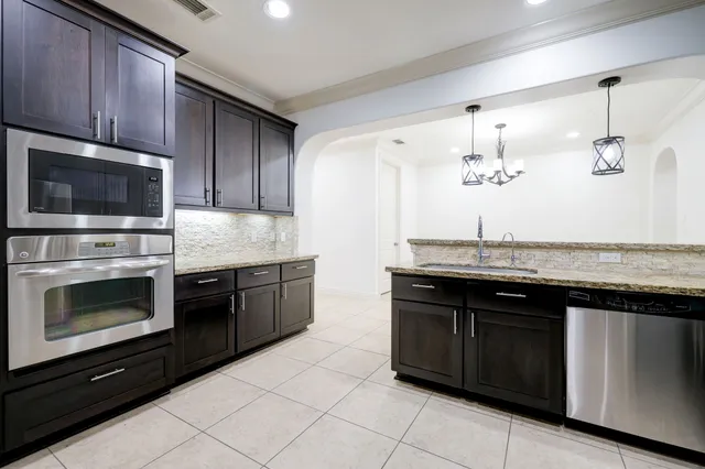 an empty room with wooden floor chandelier fan and windows