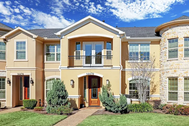 front view of a brick house with a yard