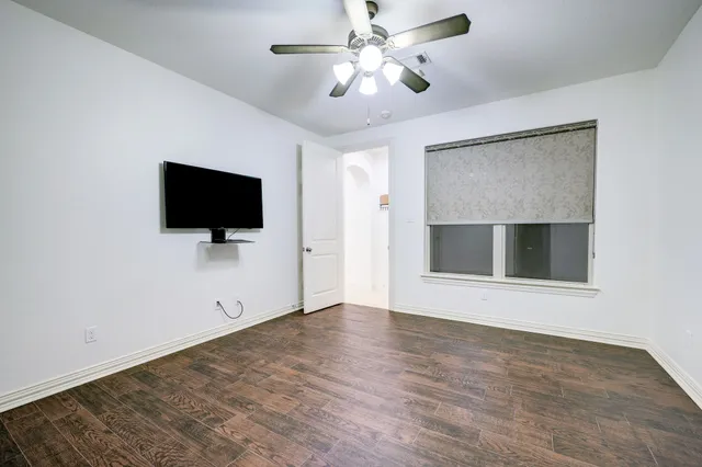 a bathroom with a granite countertop sink mirror vanity and toilet