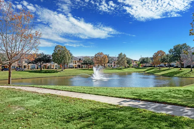 a view of a lake with houses in the background