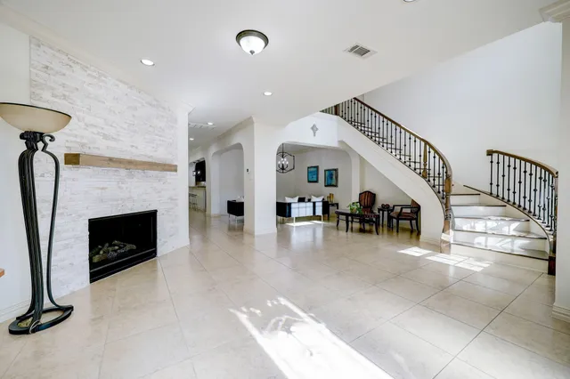 a living room with furniture and a fireplace