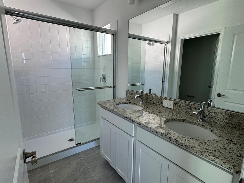 9026 Optimist Way Palmetto, FL 34221 - Photo 13 of 21 a bathroom with a granite countertop sink and a mirror