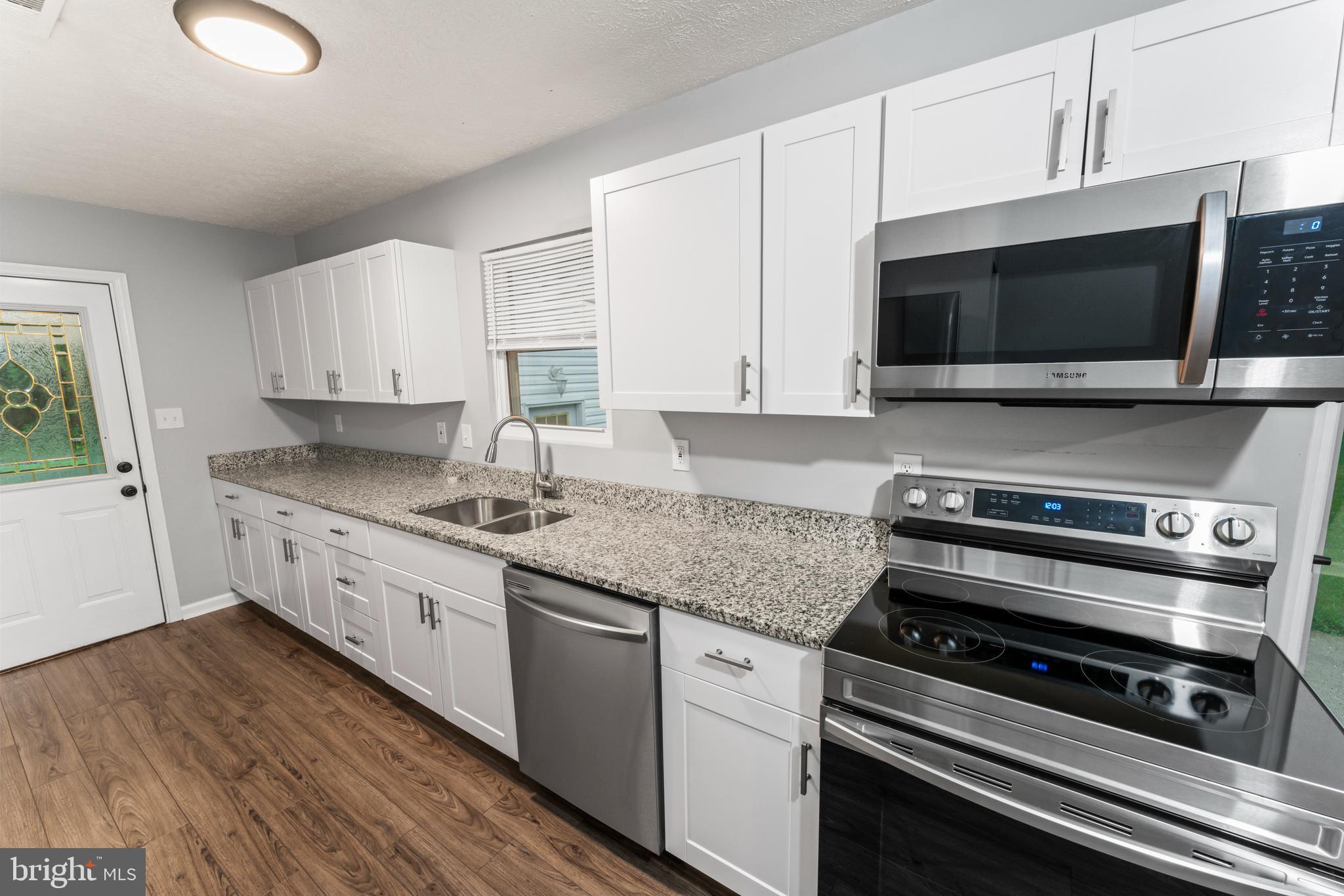 4 River Ridge Lane Fredericksburg, VA 22406 - Photo 11 of 43 a kitchen with stainless steel appliances a stove a microwave and cabinets