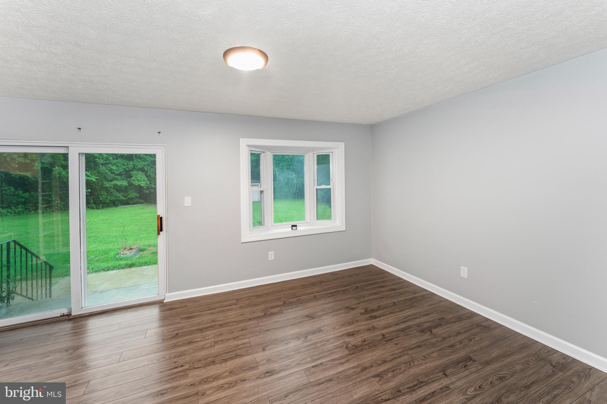 4 River Ridge Lane Fredericksburg, VA 22406 - Photo 16 of 43 a view of an empty room with wooden floor and a window
