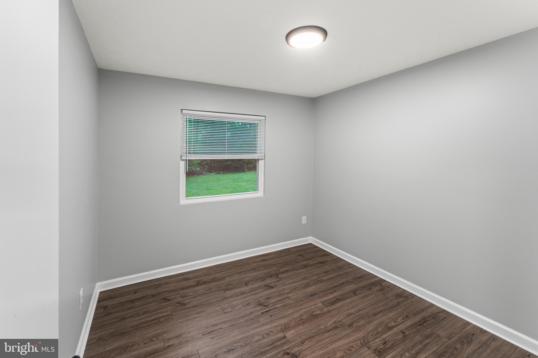 4 River Ridge Lane Fredericksburg, VA 22406 - Photo 22 of 43 an empty room with wooden floor and a window