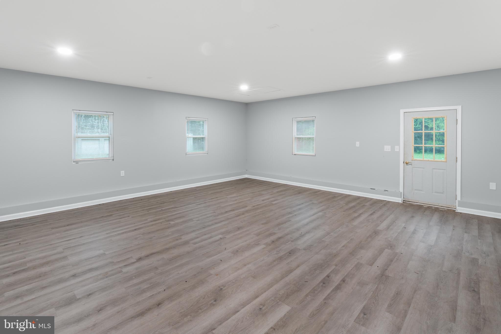 4 River Ridge Lane Fredericksburg, VA 22406 - Photo 35 of 43 an empty room with wooden floor and windows