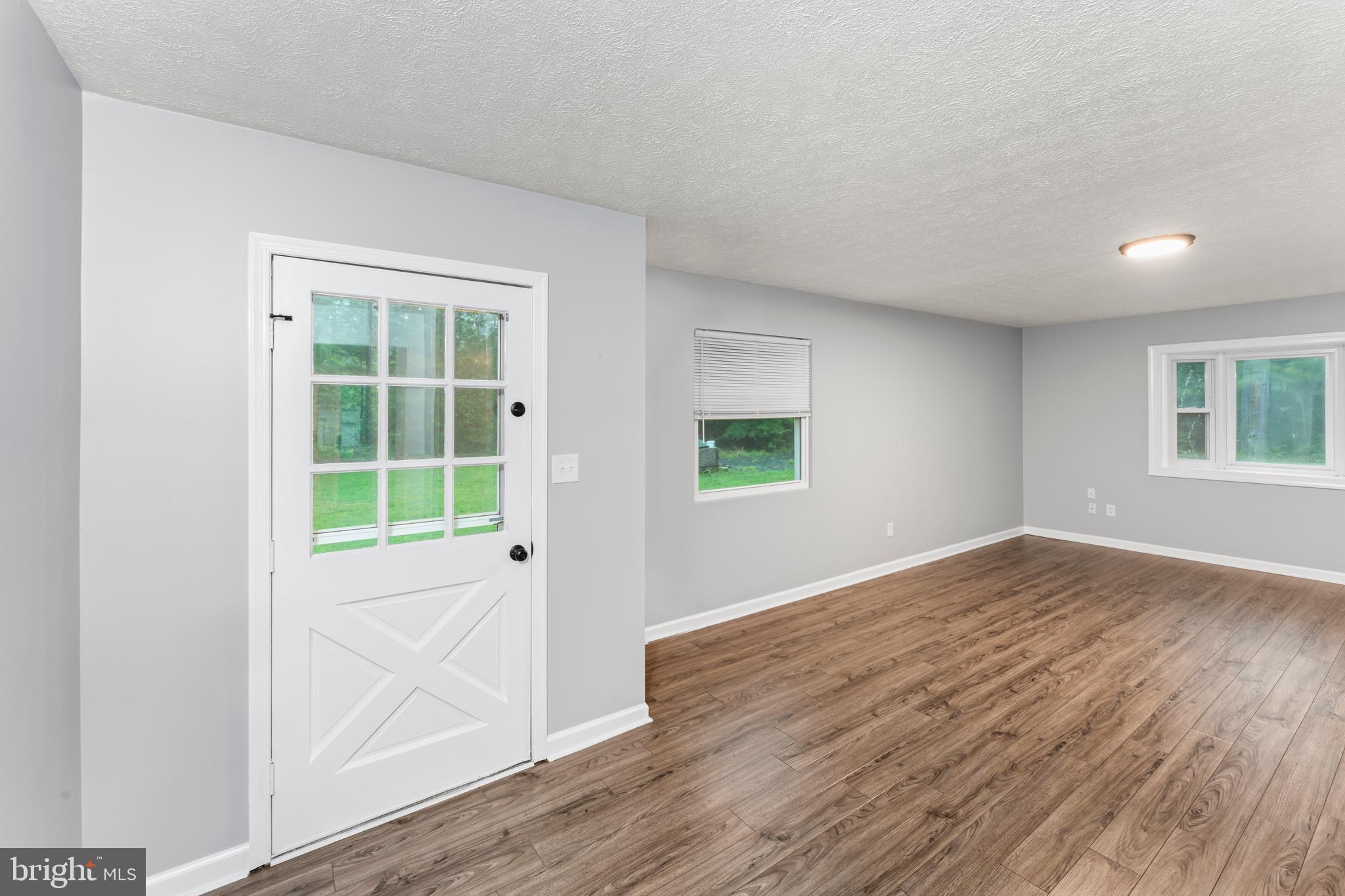 4 River Ridge Lane Fredericksburg, VA 22406 - Photo 6 of 43 an empty room with wooden floor and windows