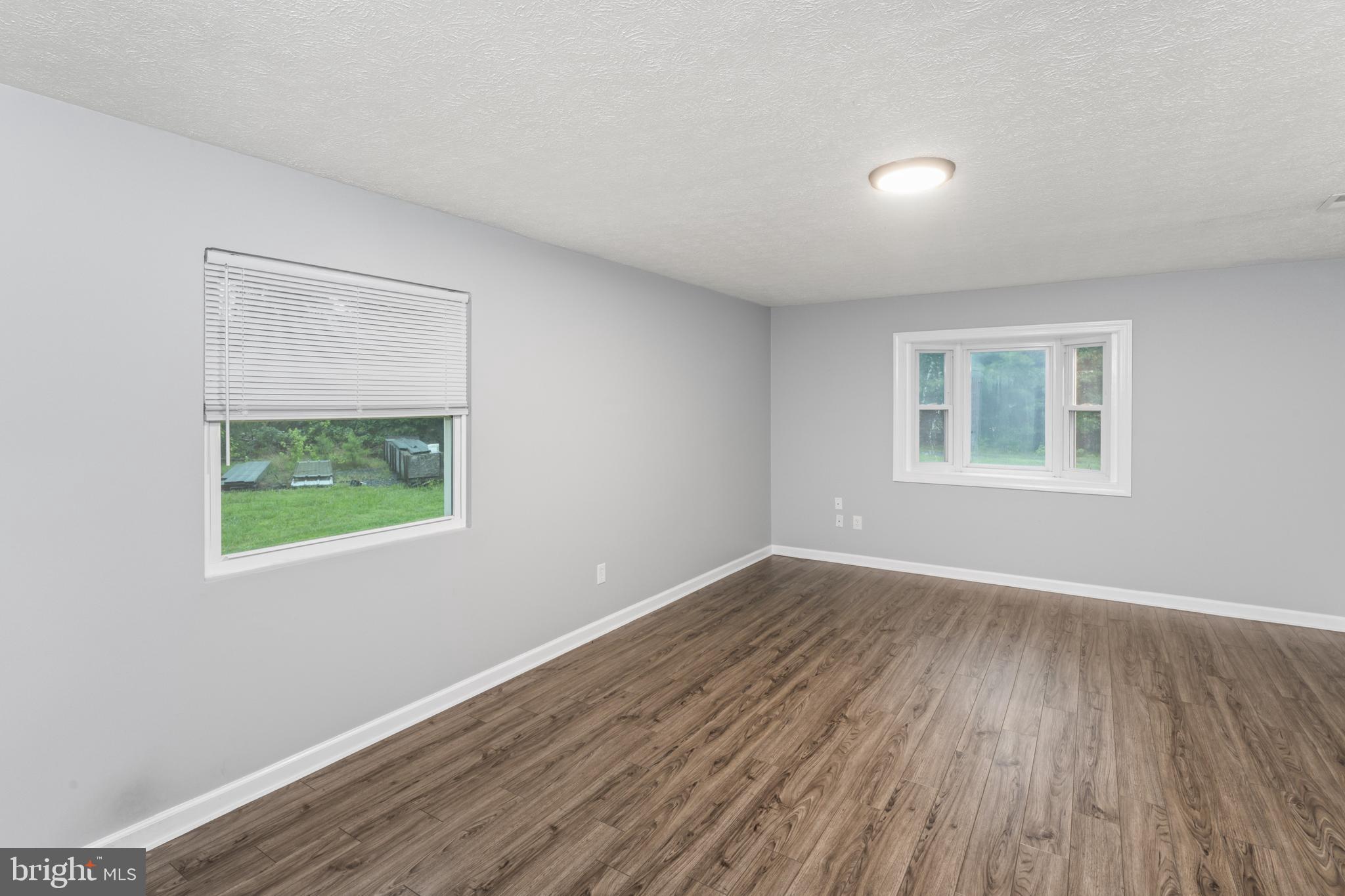 4 River Ridge Lane Fredericksburg, VA 22406 - Photo 8 of 43 a view of an empty room with wooden floor and a window