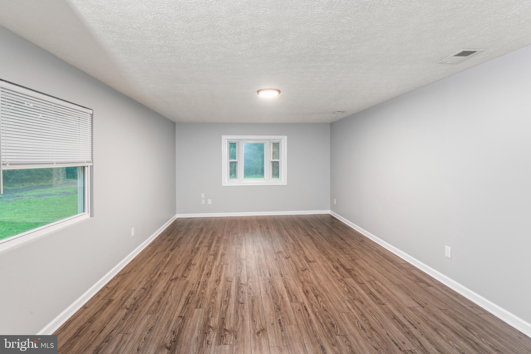 4 River Ridge Lane Fredericksburg, VA 22406 - Photo 9 of 43 wooden floor in an empty room with a window