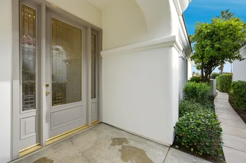 an empty room with potted plants in front of door