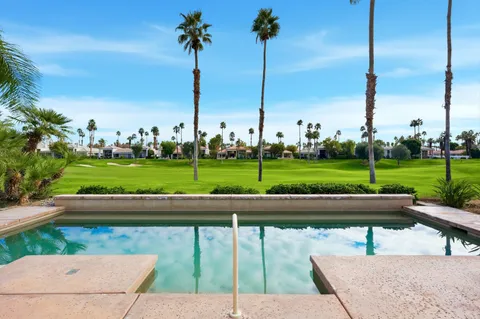 a view of a patio with a table and chairs