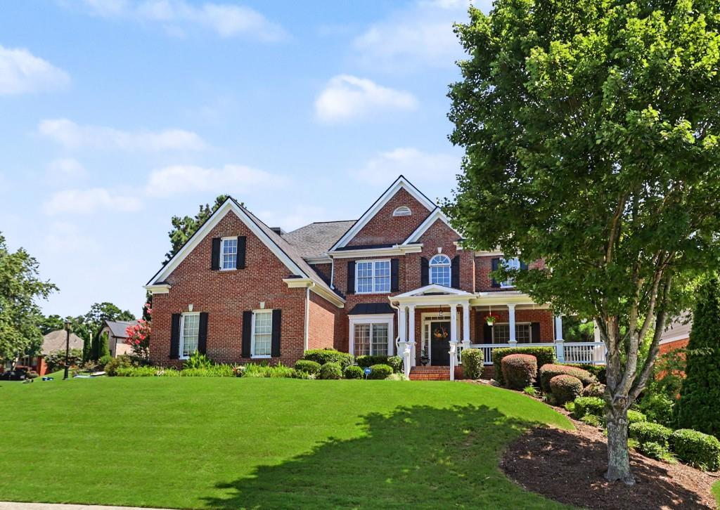 2123 Floral Ridge Drive Dacula, GA 30019 - Photo 2 of 56 a front view of a house with a garden