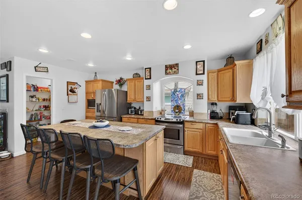 a large kitchen with a table and chairs