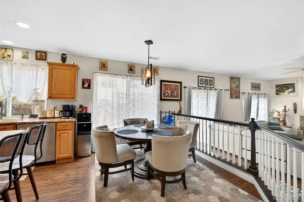 a dining room with furniture a rug and wooden floor