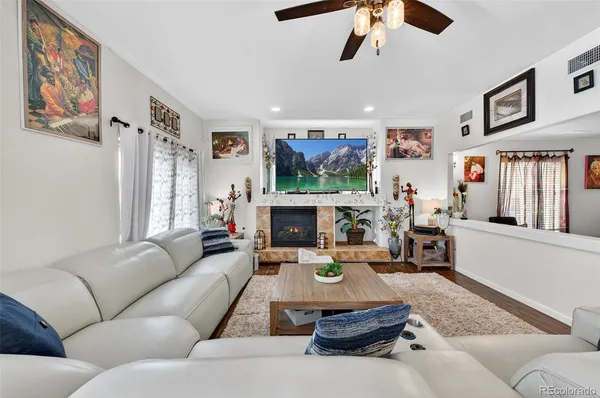 a living room with furniture fireplace and window