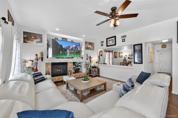 a living room with furniture a fireplace and a flat screen tv
