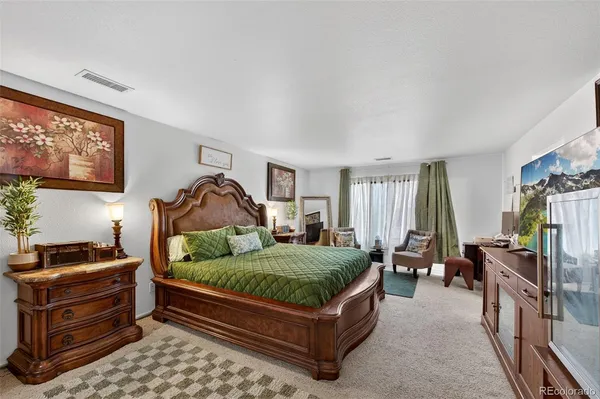 a bedroom with a bed next to a window