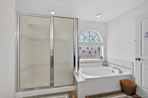 a bathroom with a bathtub and a shower