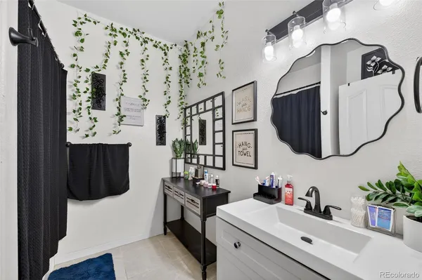 a bathroom with a sink vanity granite and a mirror