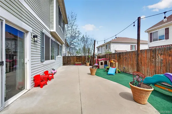 a view of a house with backyard and sitting area