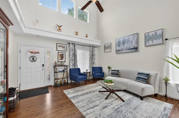 a living room with furniture and wooden floor