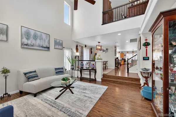 a living room with furniture and wooden floor
