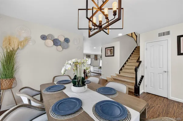 a dining room with furniture and wooden floor