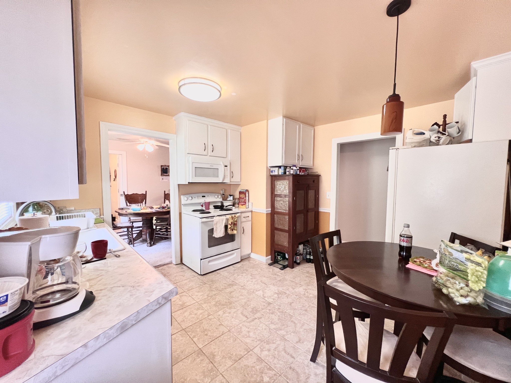 285 Spring Creek Road Lawrenceburg, TN 38464 - Photo 29 of 45 a room with stainless steel appliances kitchen island granite countertop a dining table chairs and a refrigerator