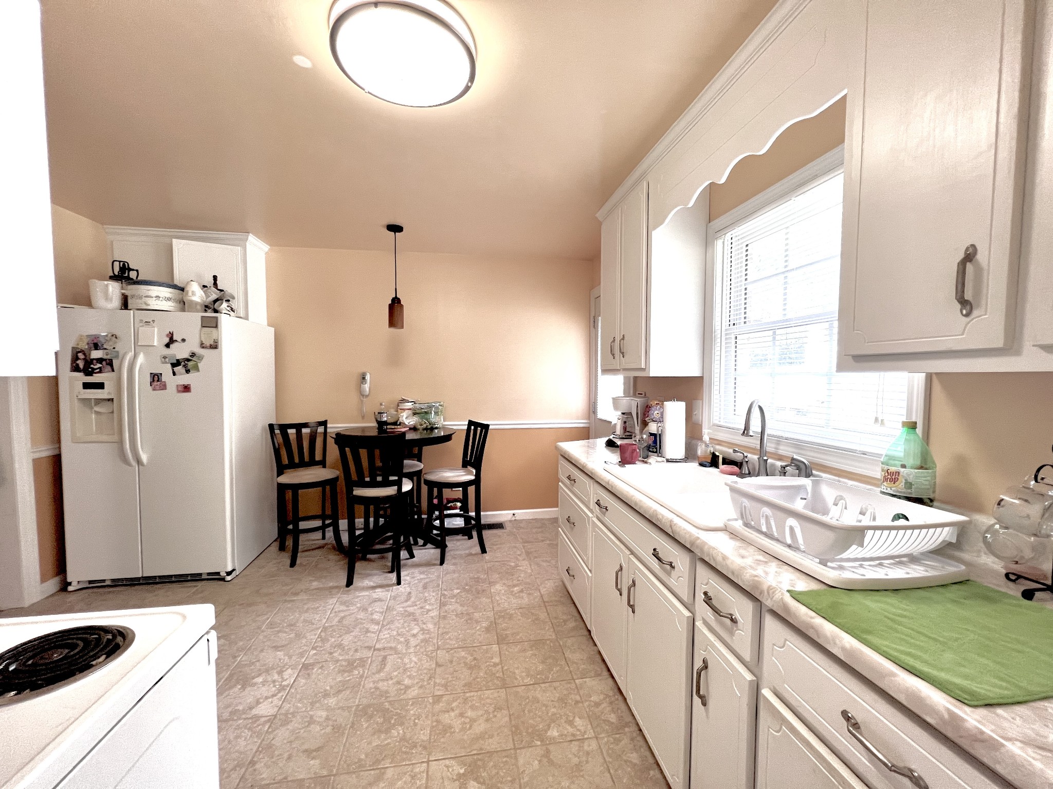 285 Spring Creek Road Lawrenceburg, TN 38464 - Photo 30 of 45 a kitchen with a sink stove and cabinets