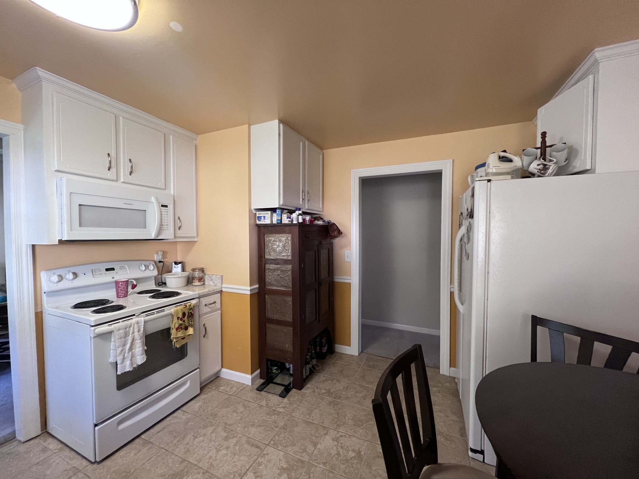 285 Spring Creek Road Lawrenceburg, TN 38464 - Photo 31 of 45 a kitchen with a stove a refrigerator and cabinets