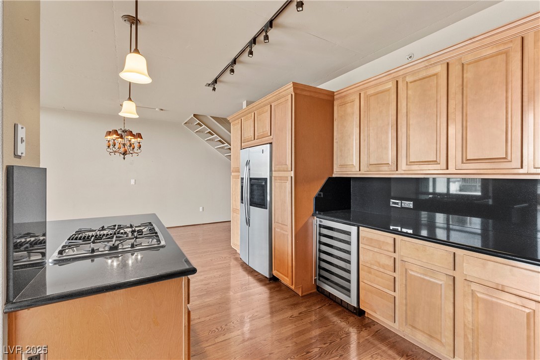 360 East Desert Inn Road, Unit 605 Las Vegas, NV 89109 - Photo 21 of 43 Kitchen featuring pendant lighting, track lighting, light wood-type flooring, wine cooler, and appliances with stainless steel finishes