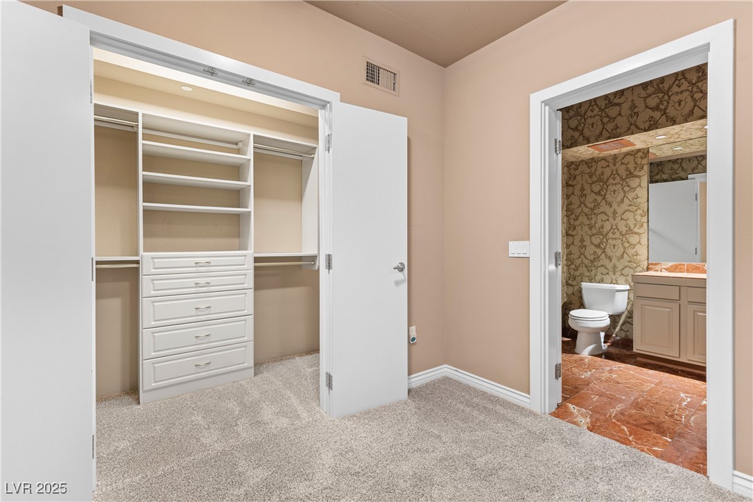 360 East Desert Inn Road, Unit 605 Las Vegas, NV 89109 - Photo 23 of 43 Downstairs bedroom featuring a closet, light colored carpet, and connected bathroom