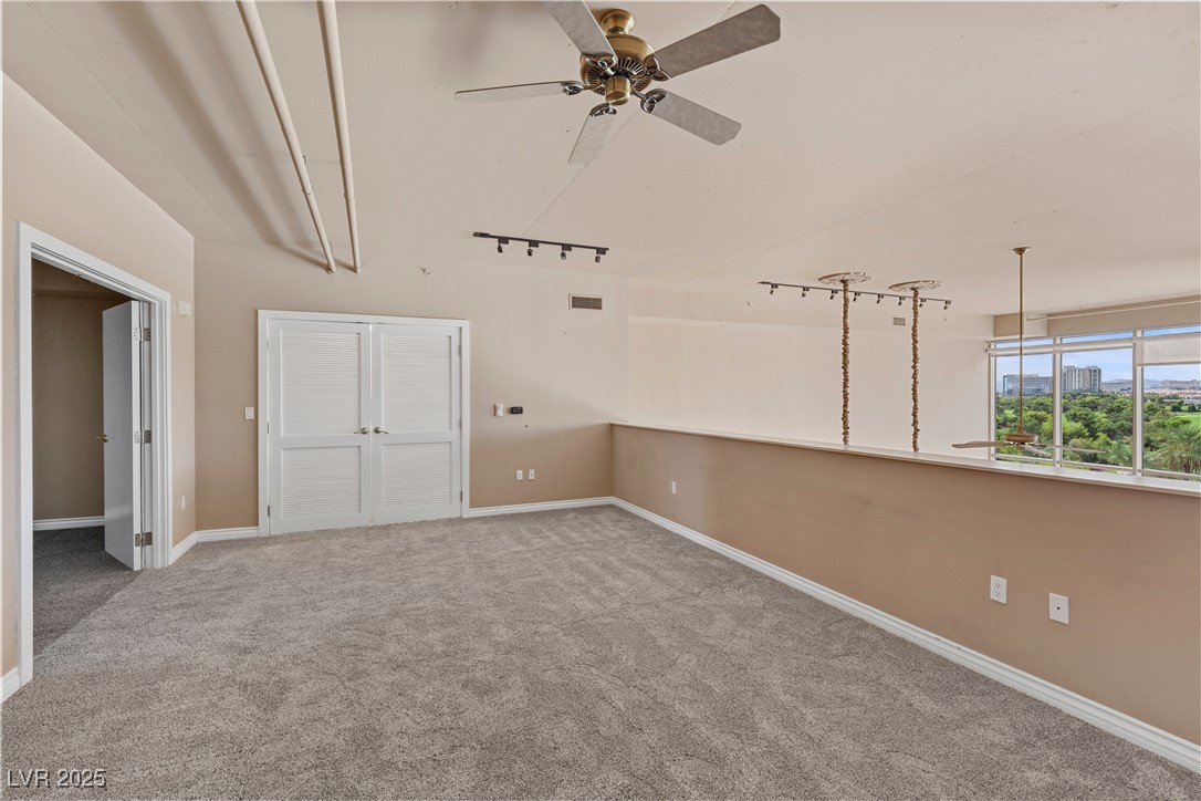 360 East Desert Inn Road, Unit 605 Las Vegas, NV 89109 - Photo 26 of 43 Carpeted sitting room with ceiling fan and rail lighting
