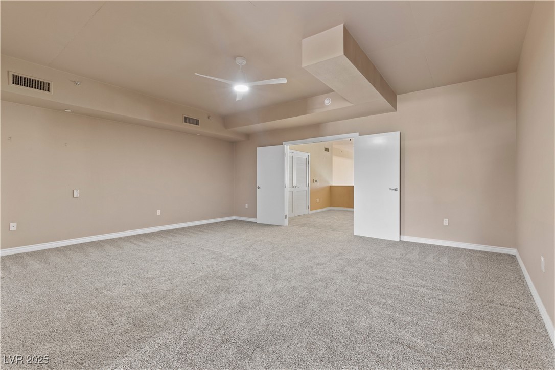 360 East Desert Inn Road, Unit 605 Las Vegas, NV 89109 - Photo 30 of 43 Unfurnished room with light carpet and ceiling fan