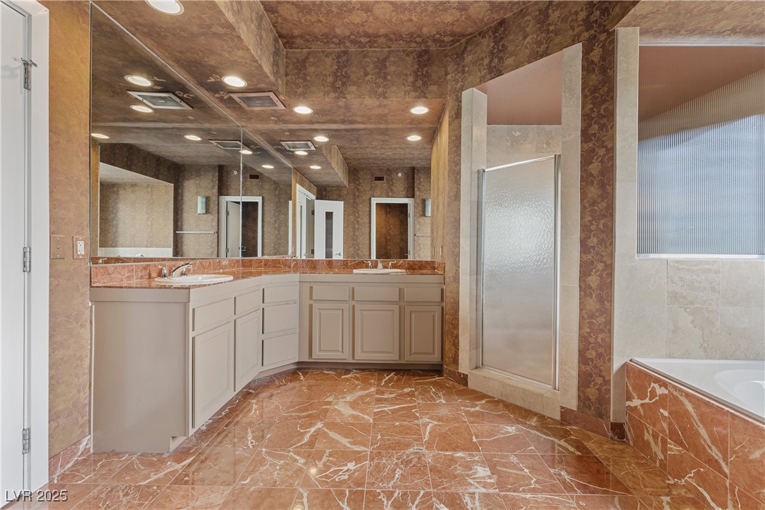 360 East Desert Inn Road, Unit 605 Las Vegas, NV 89109 - Photo 32 of 43 Bathroom with a shower stall, a garden tub, double vanity, and recessed lighting