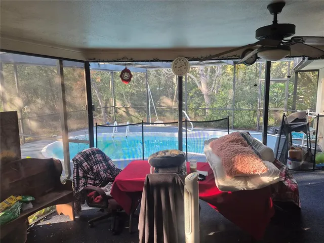 a view of a city from a dining room with furniture and floor to ceiling window