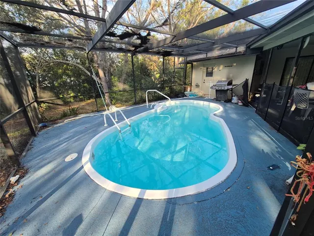 a view of a swimming pool with a patio