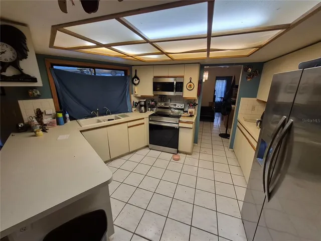 a kitchen with a sink a stove and a refrigerator