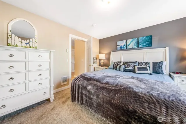 a bedroom with a bed and a dresser