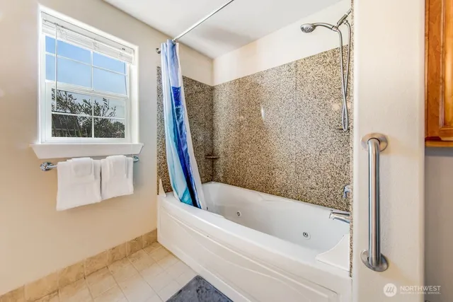 a bathroom with a bathtub and shower