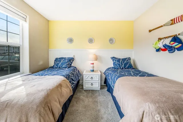 a bedroom with two beds and a window