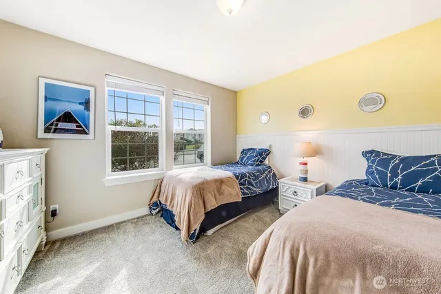 a bedroom with two beds and a window