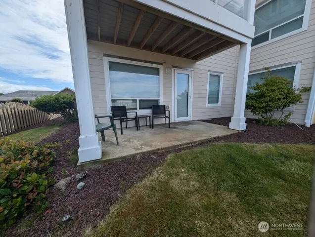 a view of a house with backyard and sitting area