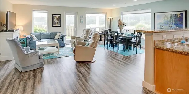 a living room with furniture a table and large window