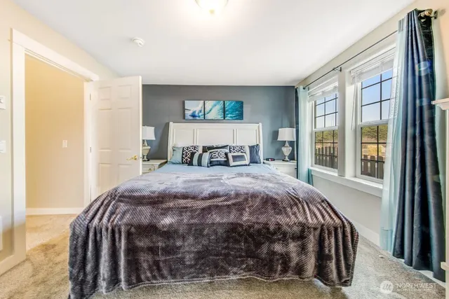 a bedroom with a large bed and a window