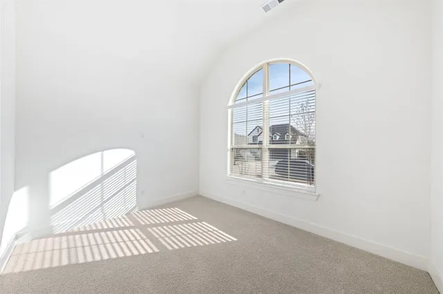 a view of a livingroom with wooden floor and a window