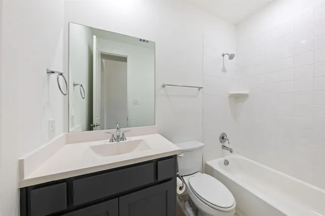 a bathroom with a sink toilet a vanity and shower